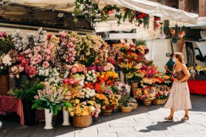 Girl walking past flower market